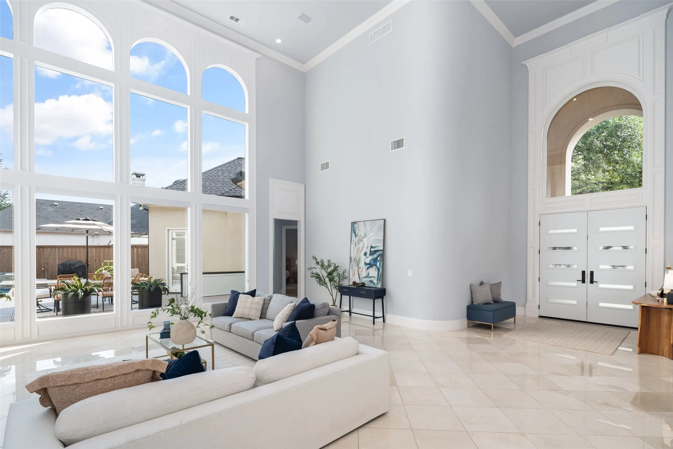 The impressive foyer flows into a spectacular great room where dramatic ceiling heights, oversized windows, and timeless architectural details make every arrival feel extraordinary.