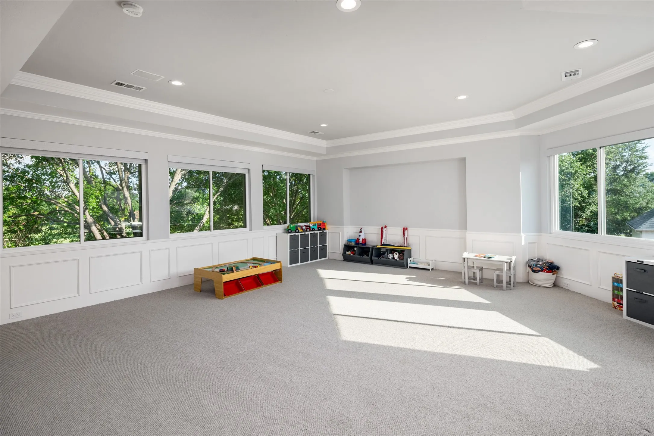 Expansive upstairs game room offers exceptional flexibility for media, recreation, fitness, or a playroom. Large windows, custom millwork, and generous dimensions create an inviting space for entertaining and everyday living.
