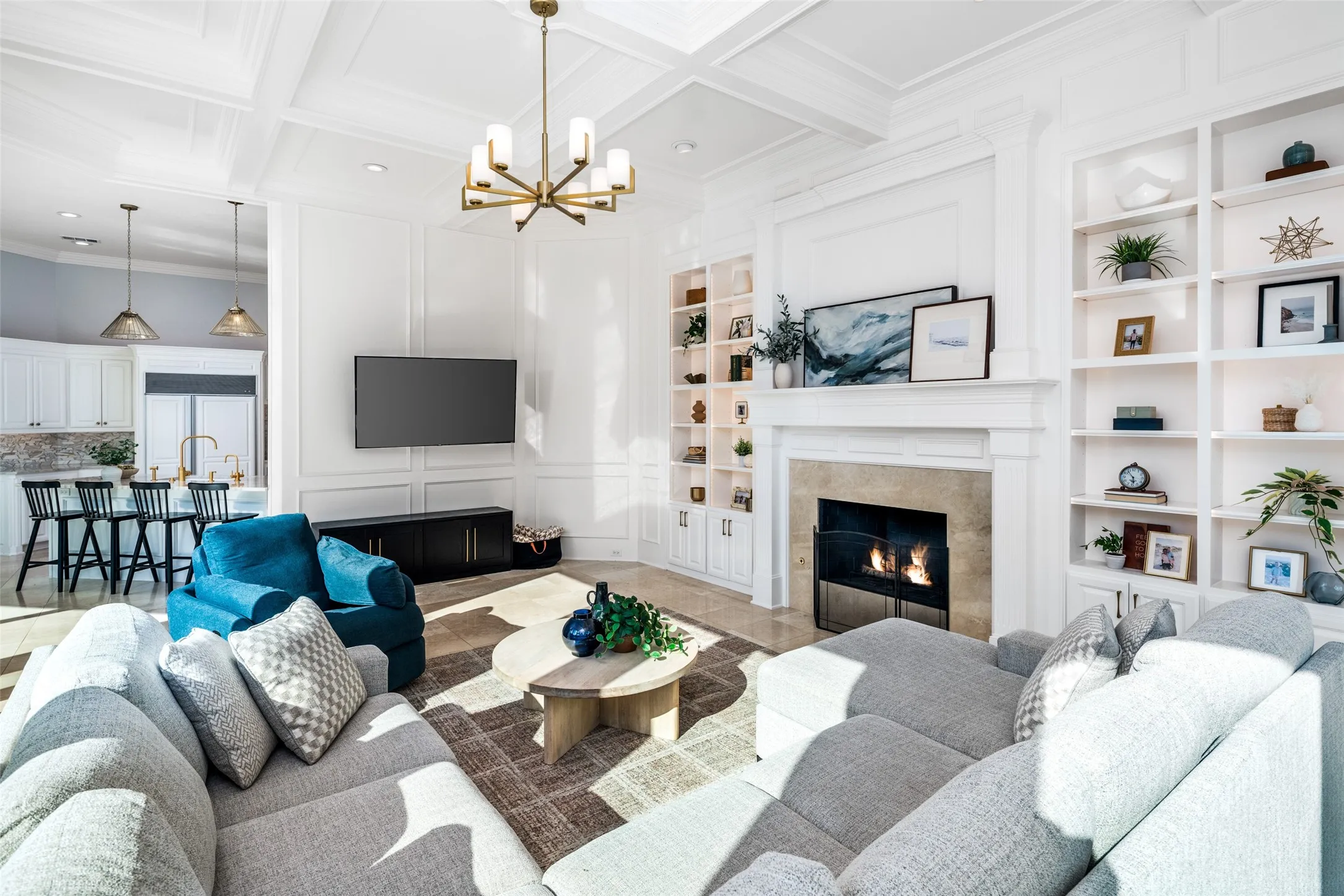 Custom millwork, built-in shelving, soaring ceilings, and oversized windows create a sophisticated yet comfortable gathering space designed for entertaining and everyday living.