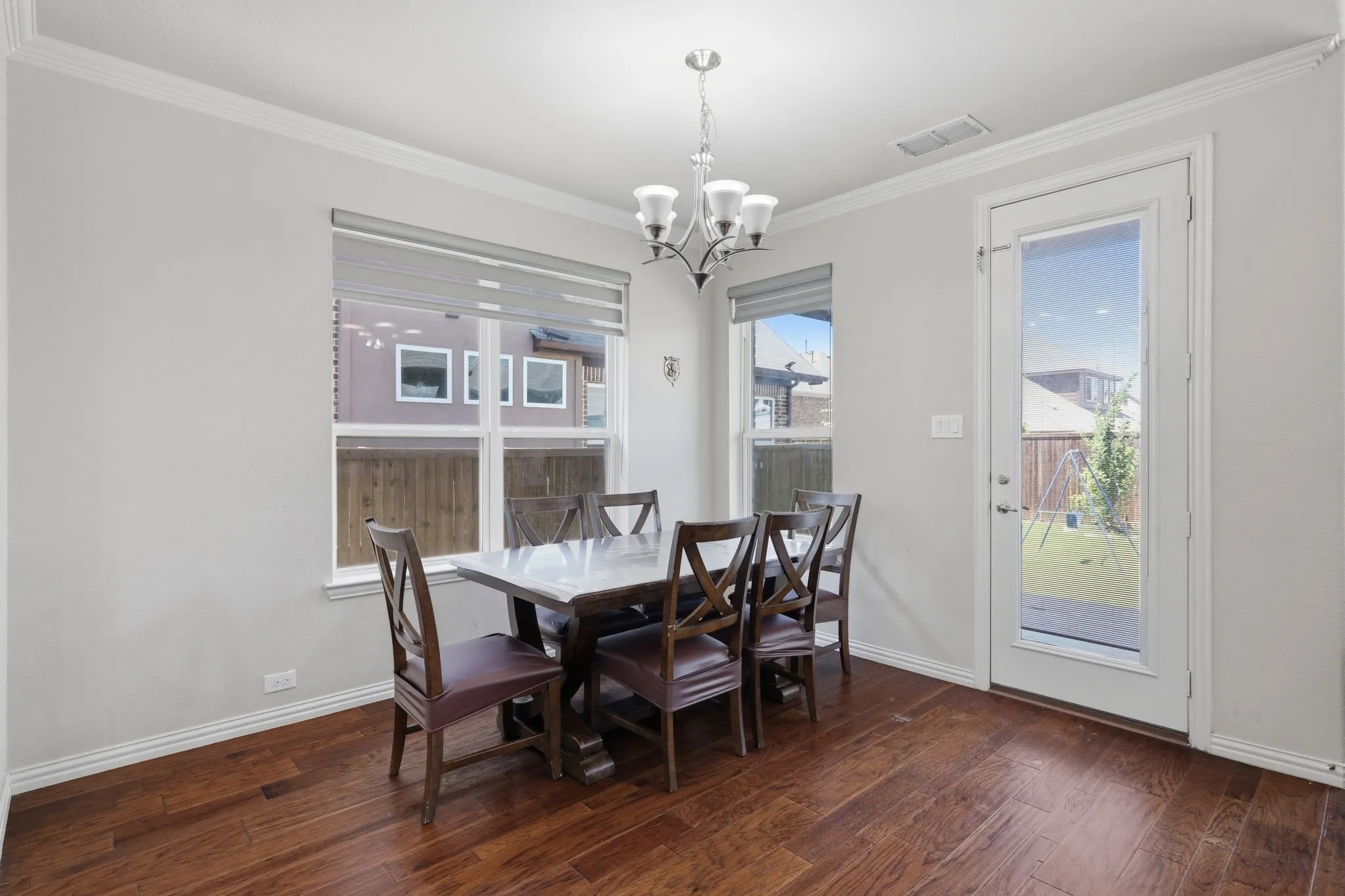 Bright interior space featuring wood-finish flooring and a glass-paneled door opening to the exterior