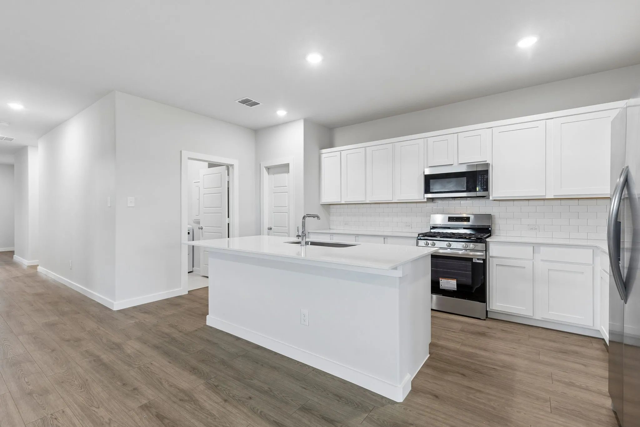 Kitchen in the Oscar home plan by Trophy Signature Homes – REPRESENTATIVE PHOTO