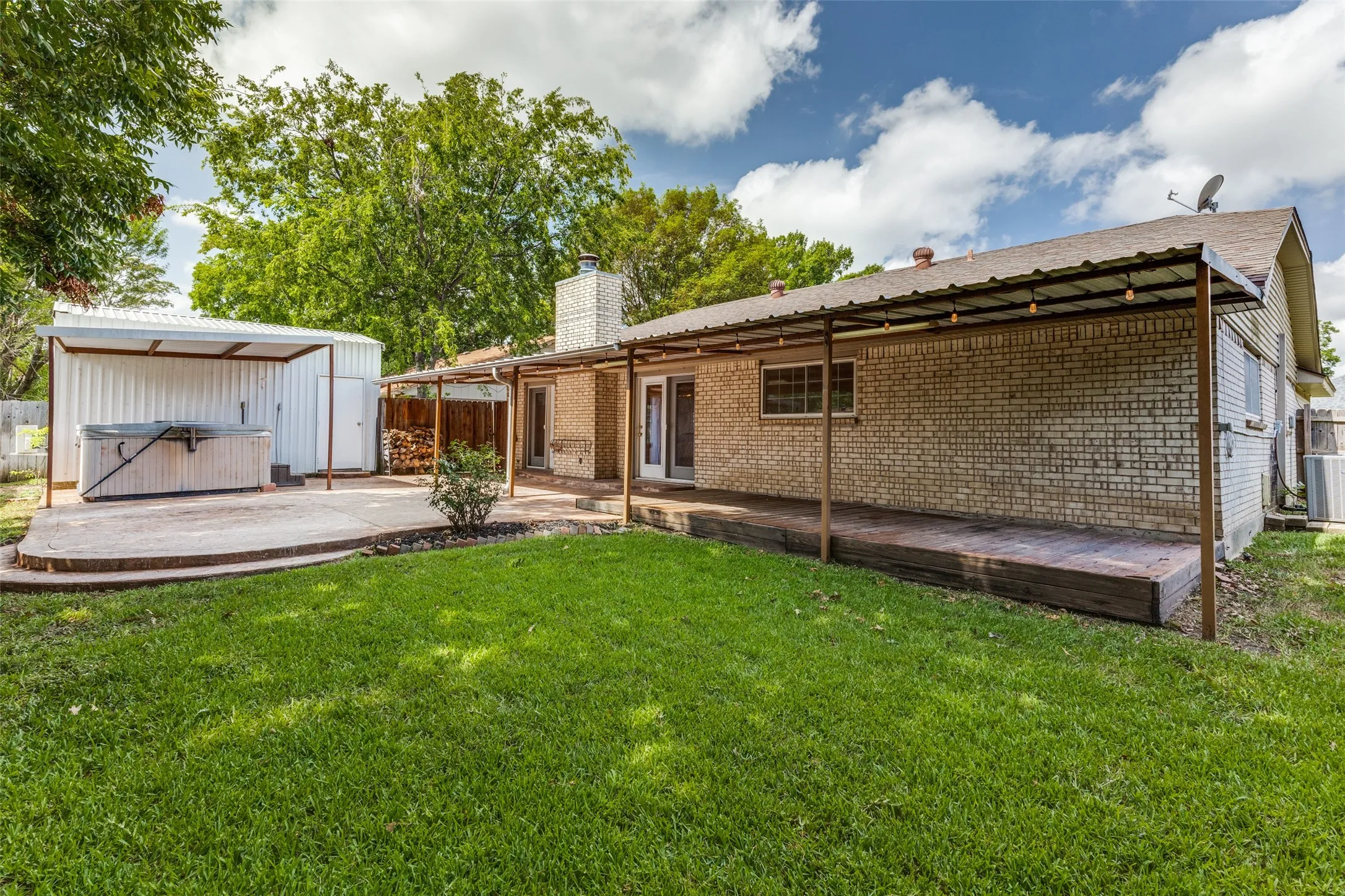 Back yard, back of house, and workshop with hot tub