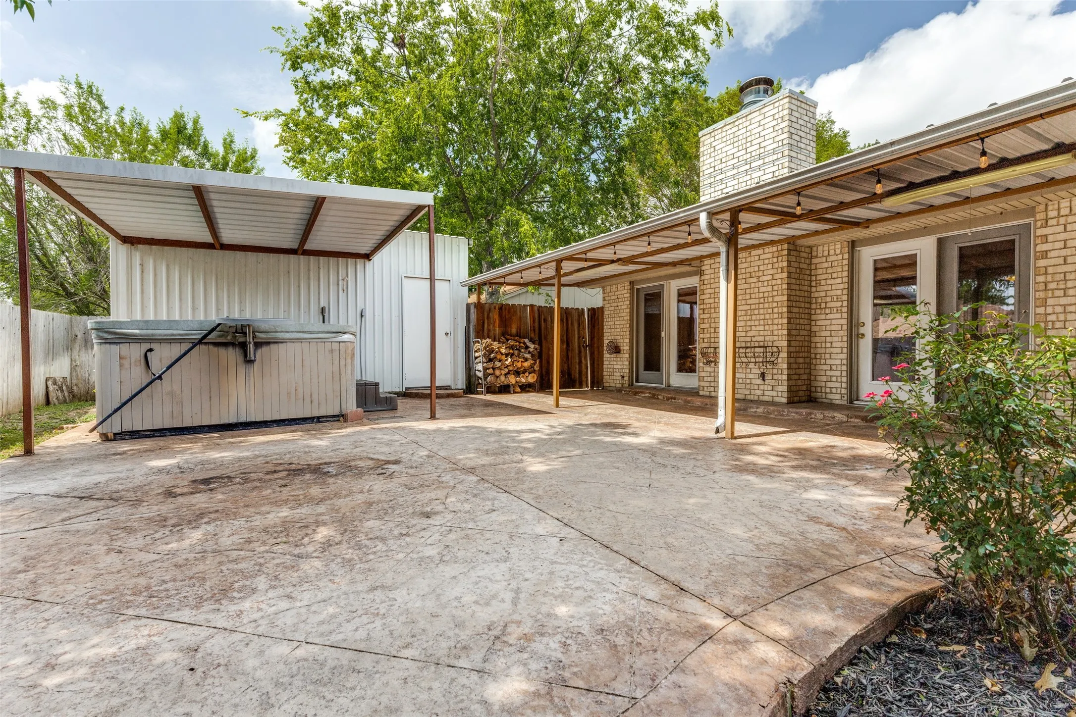 Back yard, back of house, and workshop with hot tub