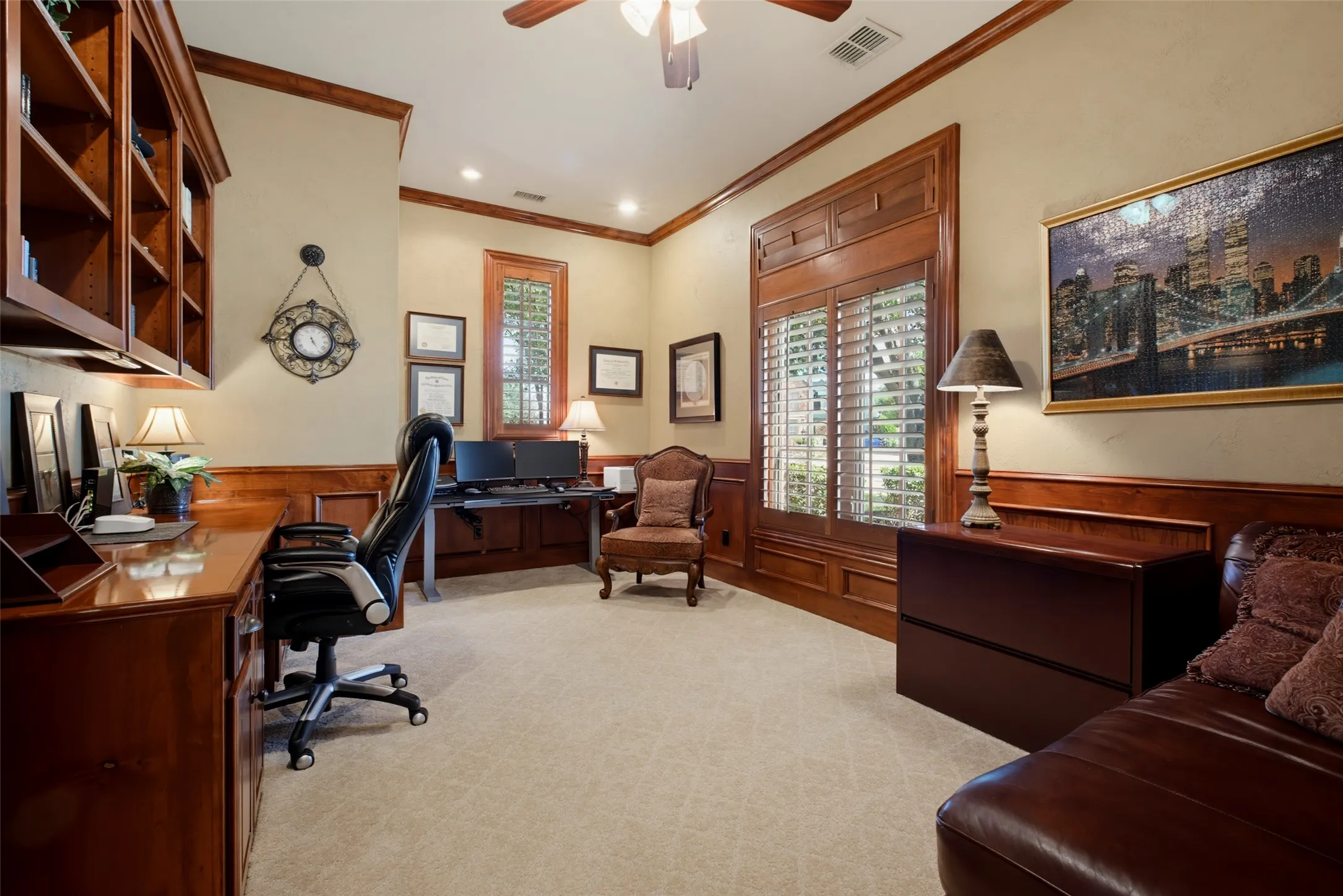 Built-in custom cabinetry, extensive wood paneling, crown molding, plantation shutters, and recessed lighting