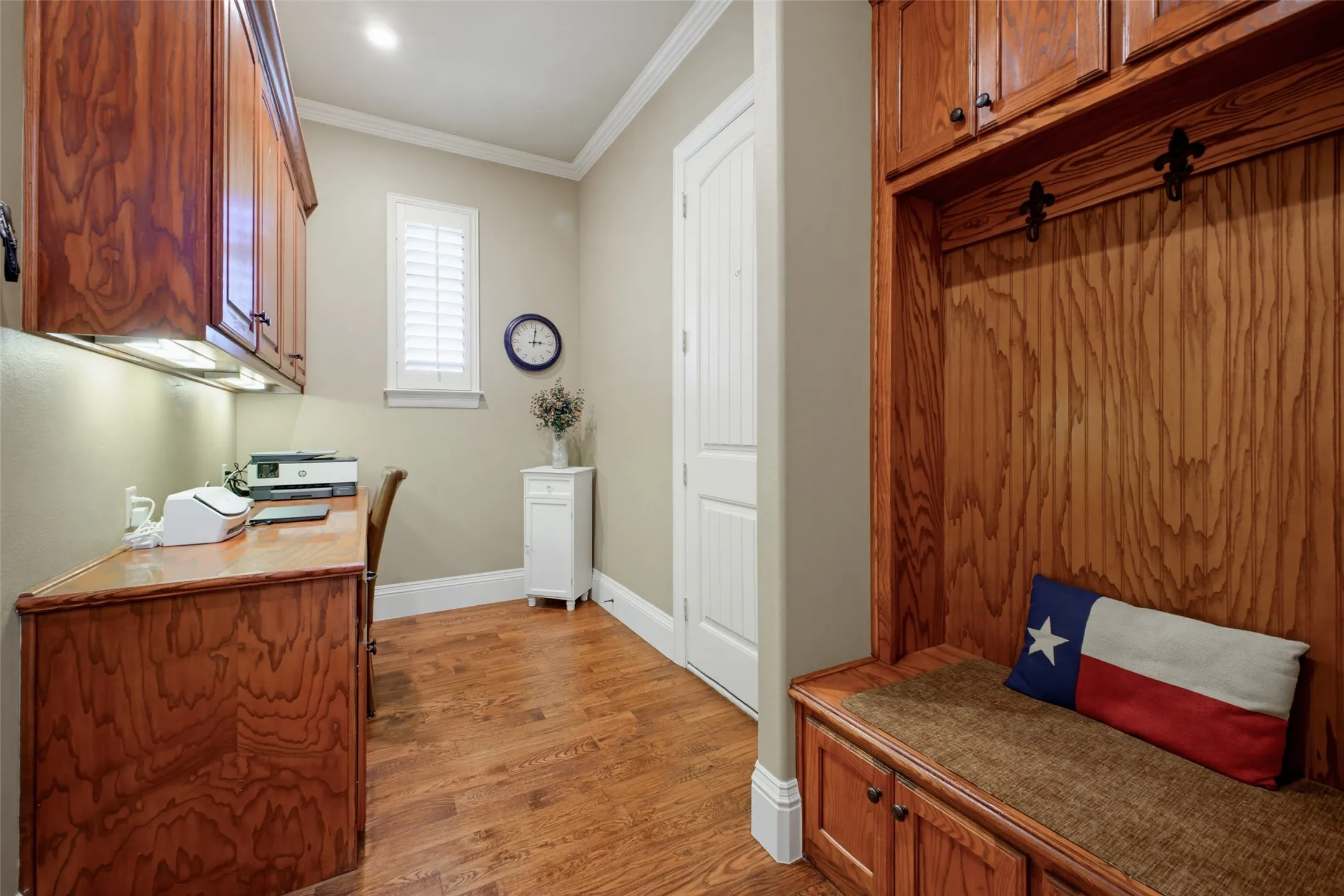 Mudroom area and secondary workspace adjacent to the garage. There is also a half bath accessible in the garage and to the pool.