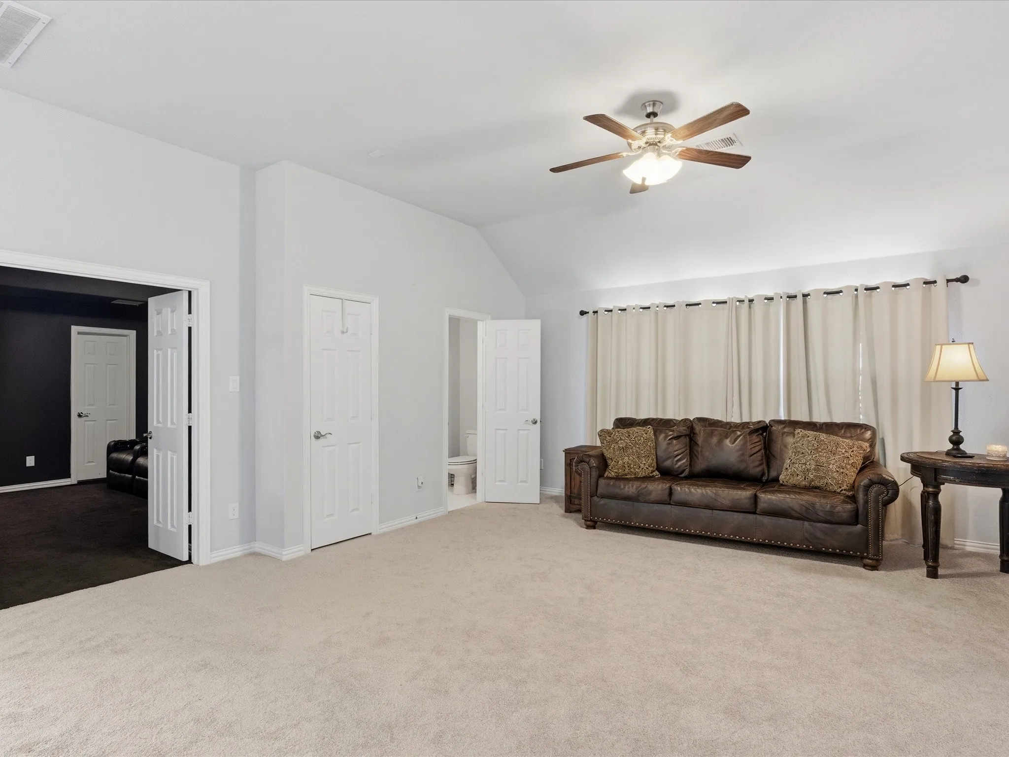 Secondary living area at top of stairs includes half bath and media room entry