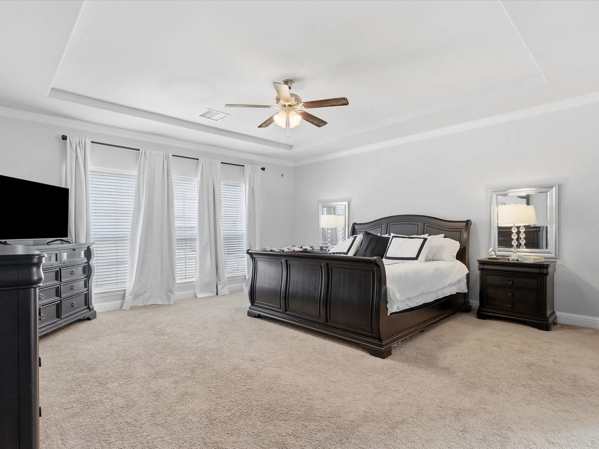 Primary bedroom is oversized with view of backyard oasis
