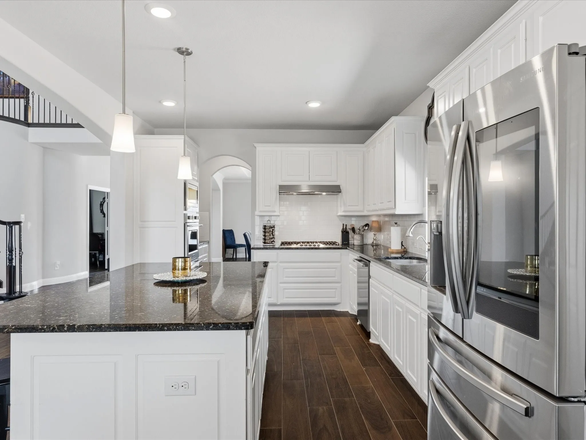 Double ovens, 5 burner gas cooktop and butler's pantry between kitchen and dining area