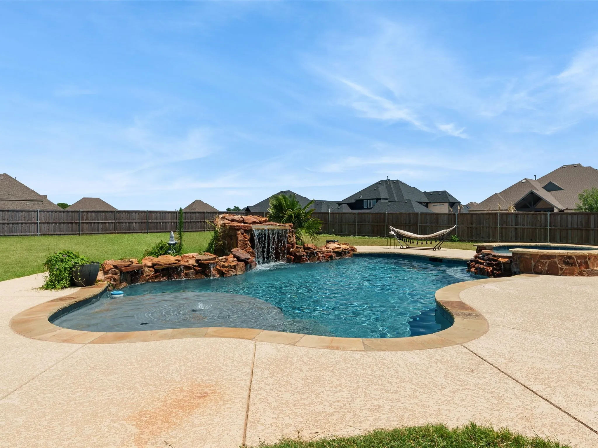 Dazzling heated saltwater pool with waterfall and spa