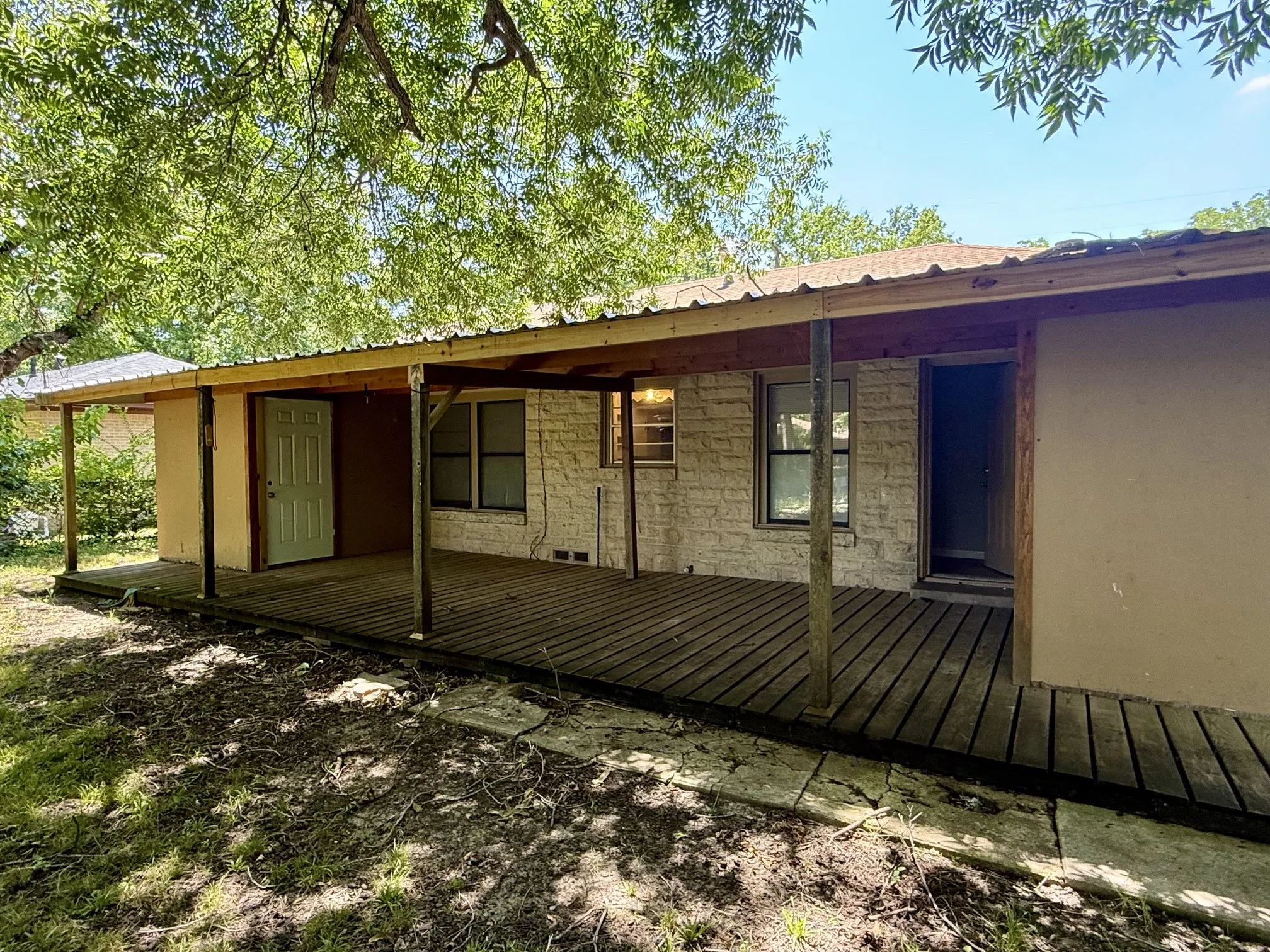 Covered Deck with two ample size storage rooms on either side