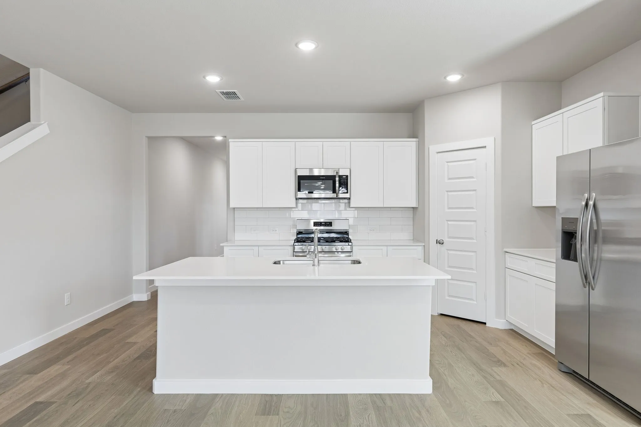 Kitchen in the Holden home plan by Trophy Signature Homes – REPRESENTATIVE PHOTO