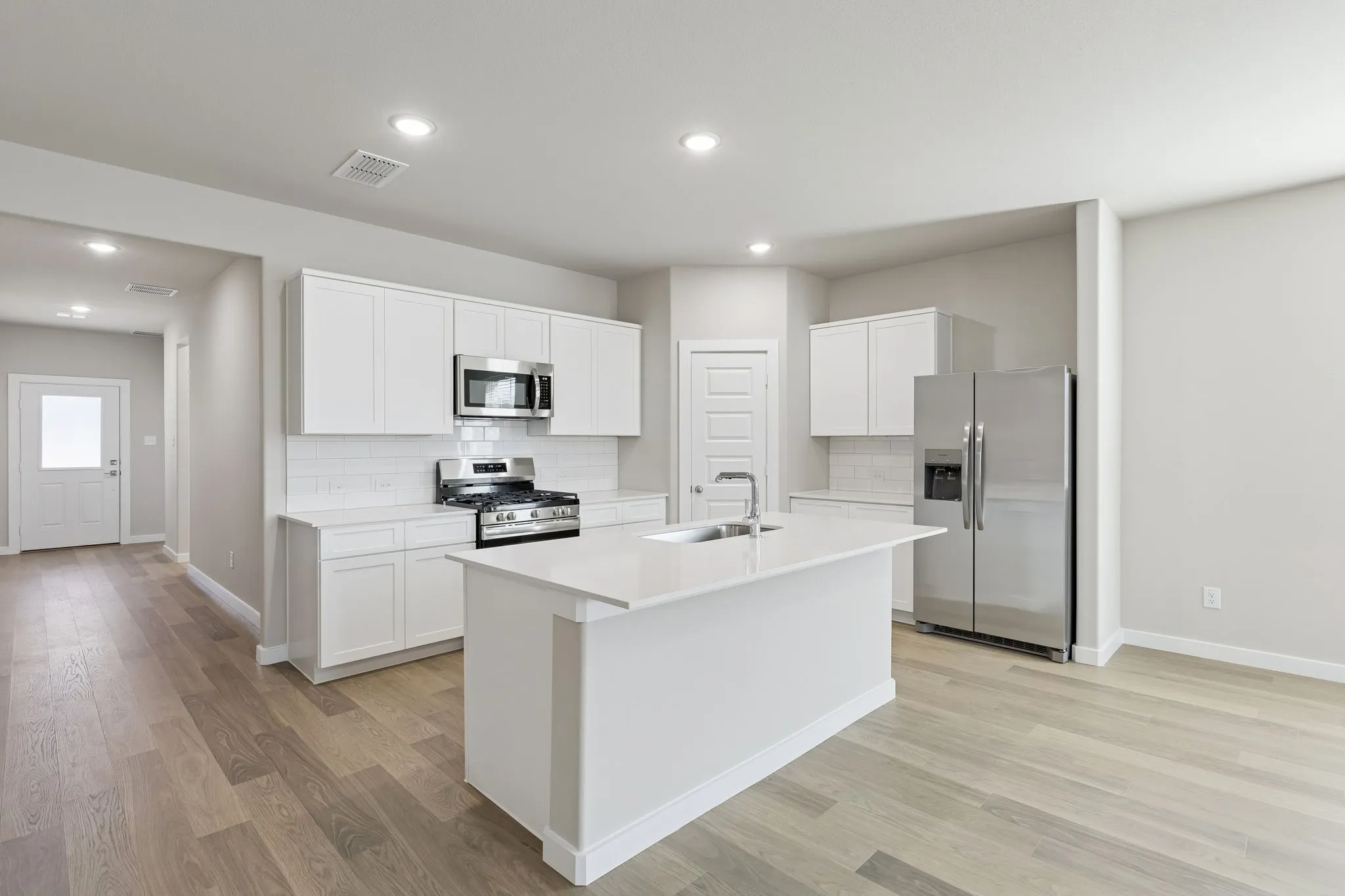 Kitchen in the Holden home plan by Trophy Signature Homes – REPRESENTATIVE PHOTO