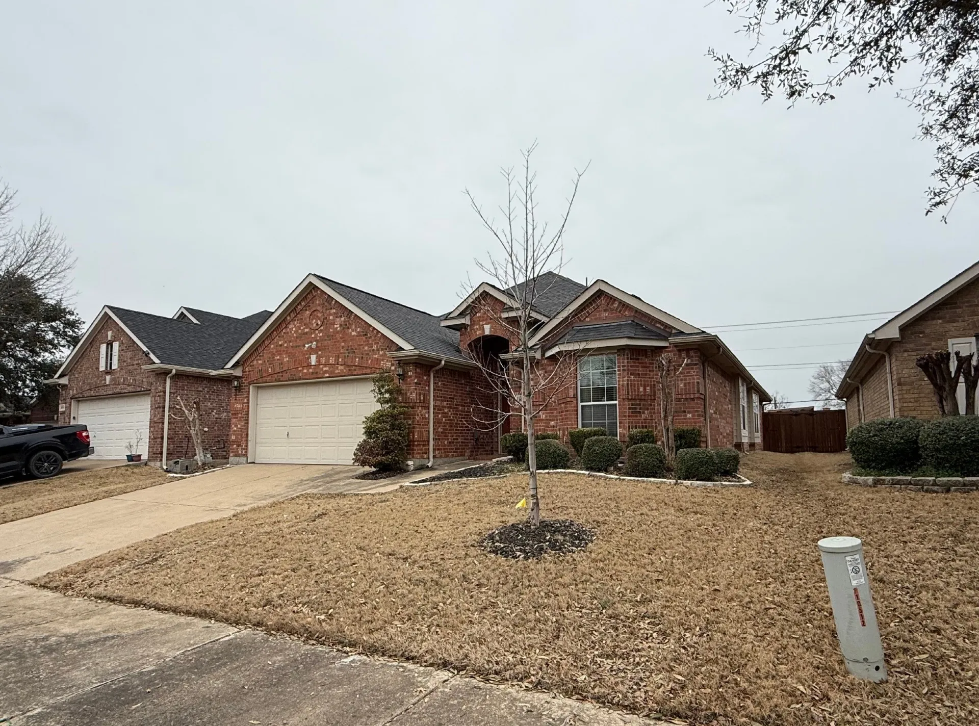 Traditional brick exterior with an attached two-car garage