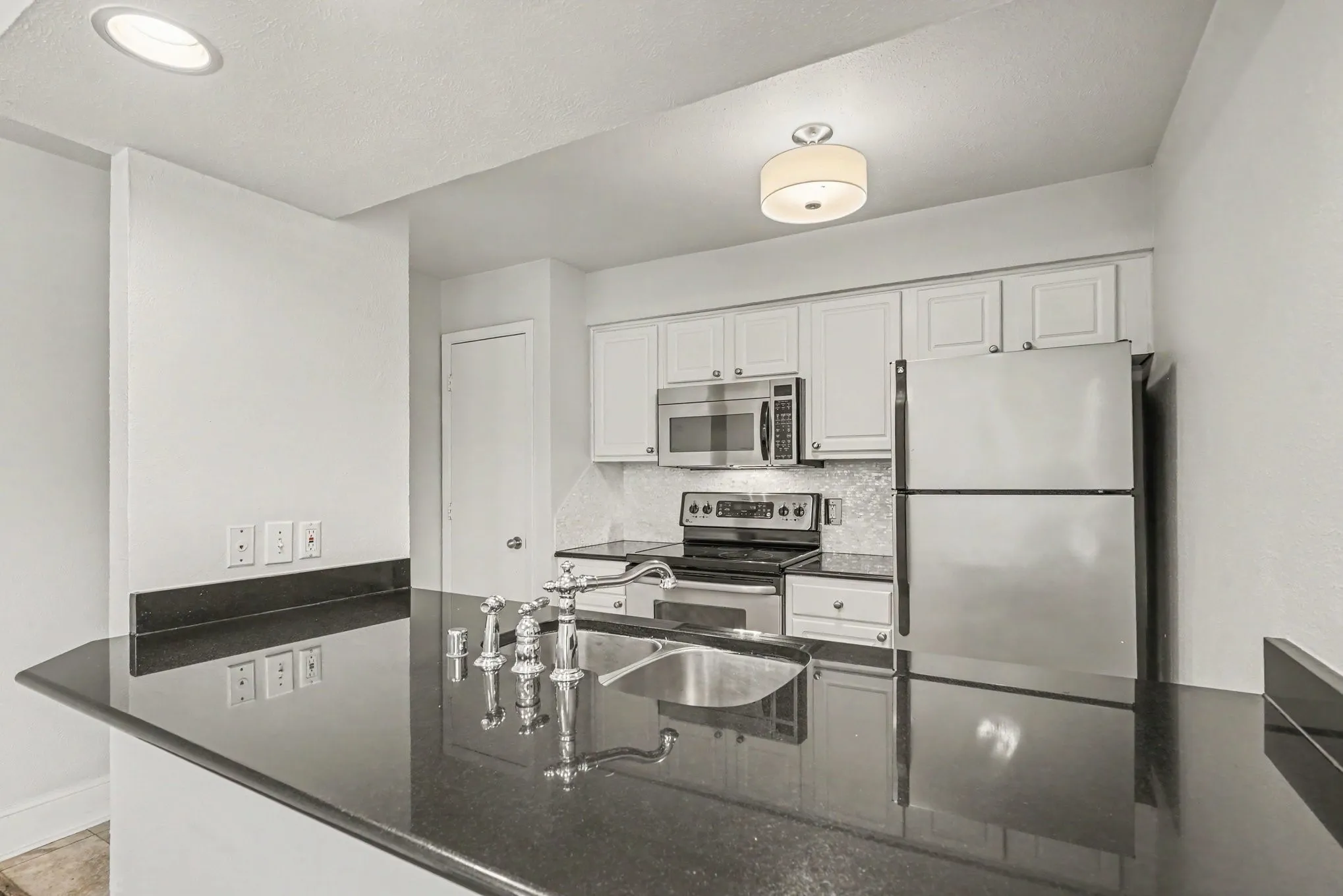 Kitchen view showing the spacious granite breakfast bar and counter.