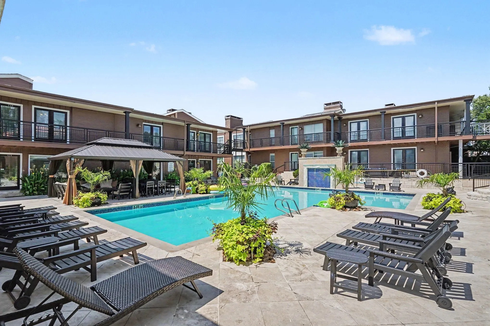 Tuscany's resort-style swimming pool has an integrated fountain surrounded by a tiled paver deck.  All seating and cabana covers are new.