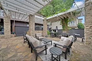 Outdoor seating adjacent to the fountain with two gas grills at the back.