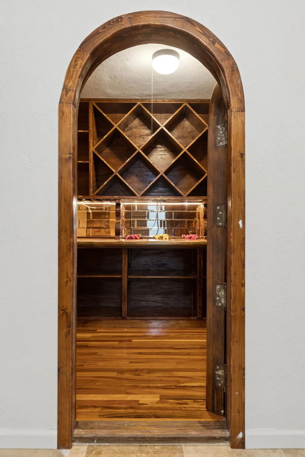 Wine area featuring arched walkways and a textured wall