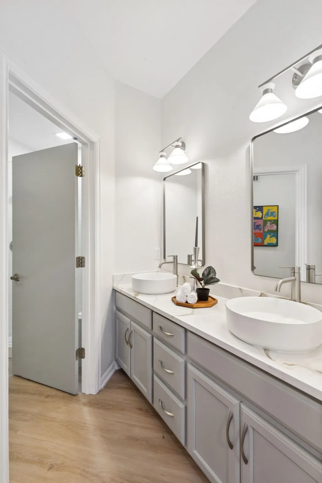 Bathroom featuring double vanity and light wood-style floors