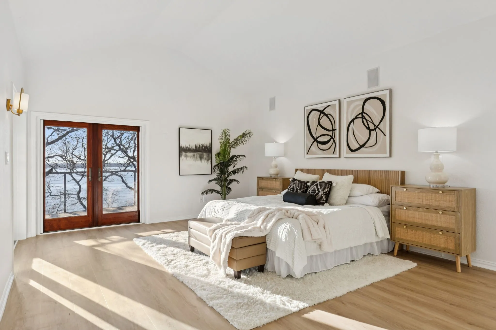 Bedroom with french doors, vaulted ceiling, and wood finished floors