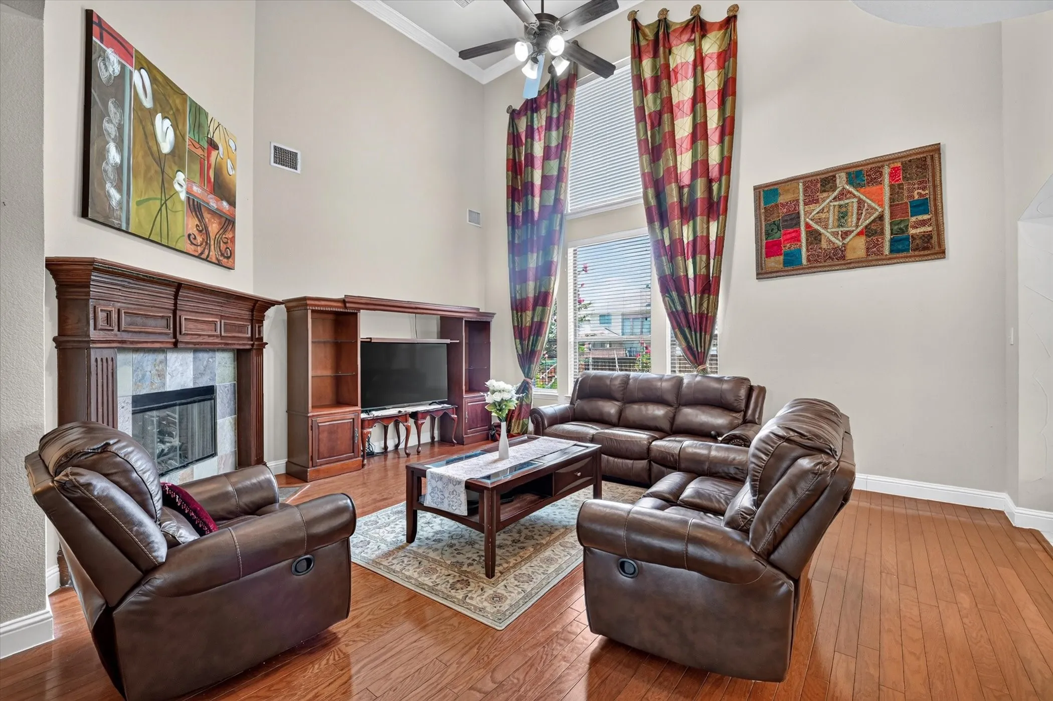 Living space with high ceilings and wood-finish flooring