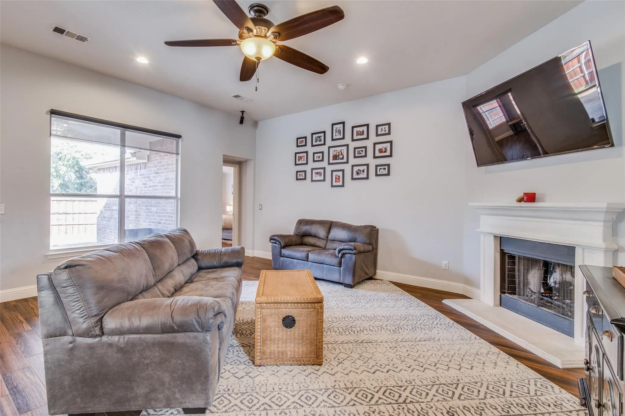 Living room featuring wood-finish flooring, recessed lighting, and a ceiling fan with integrated light fixture