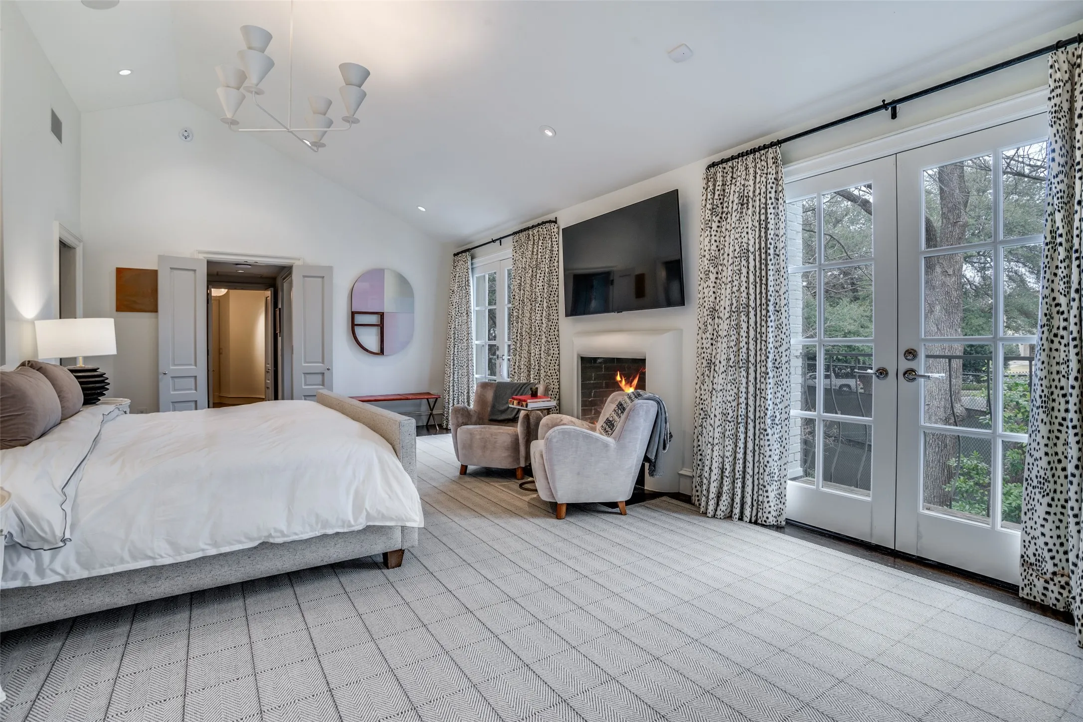 Primary bedroom doors open to a balcony