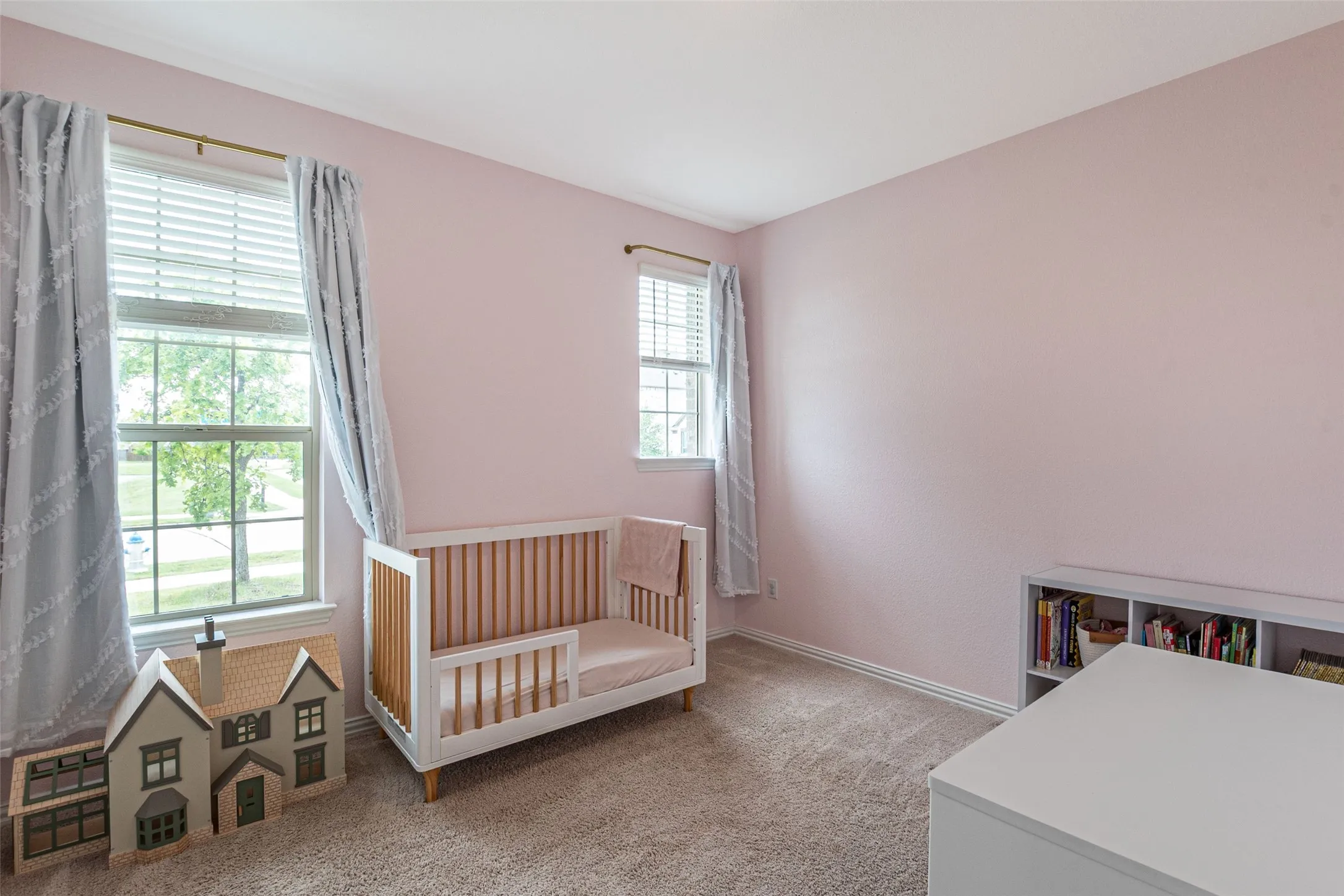 Room with pink walls and light-colored carpet