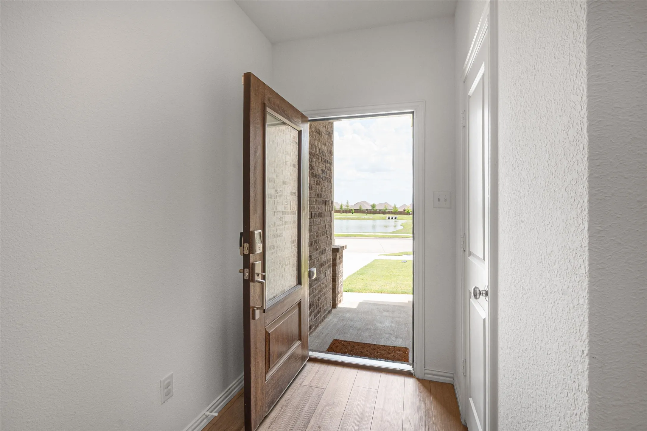 Open the front door to an amazing view of a pond with a fountain and hiking/biking trails.