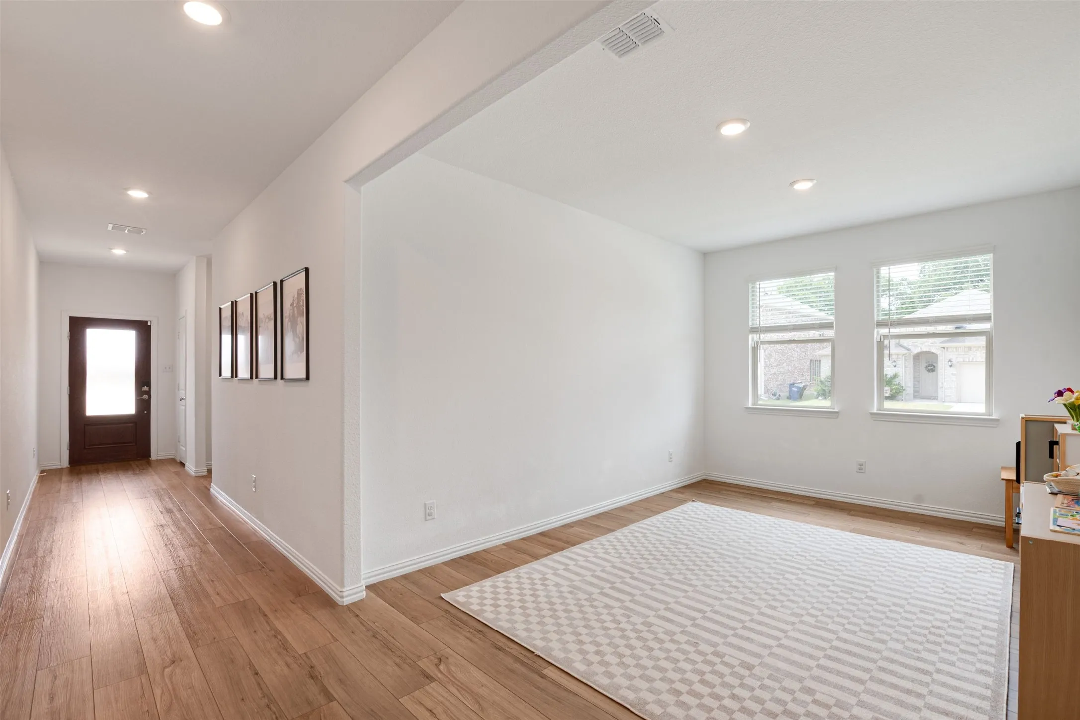 Long hallway with a flex room to convert into a formal dining, media room, office or extra living room space.