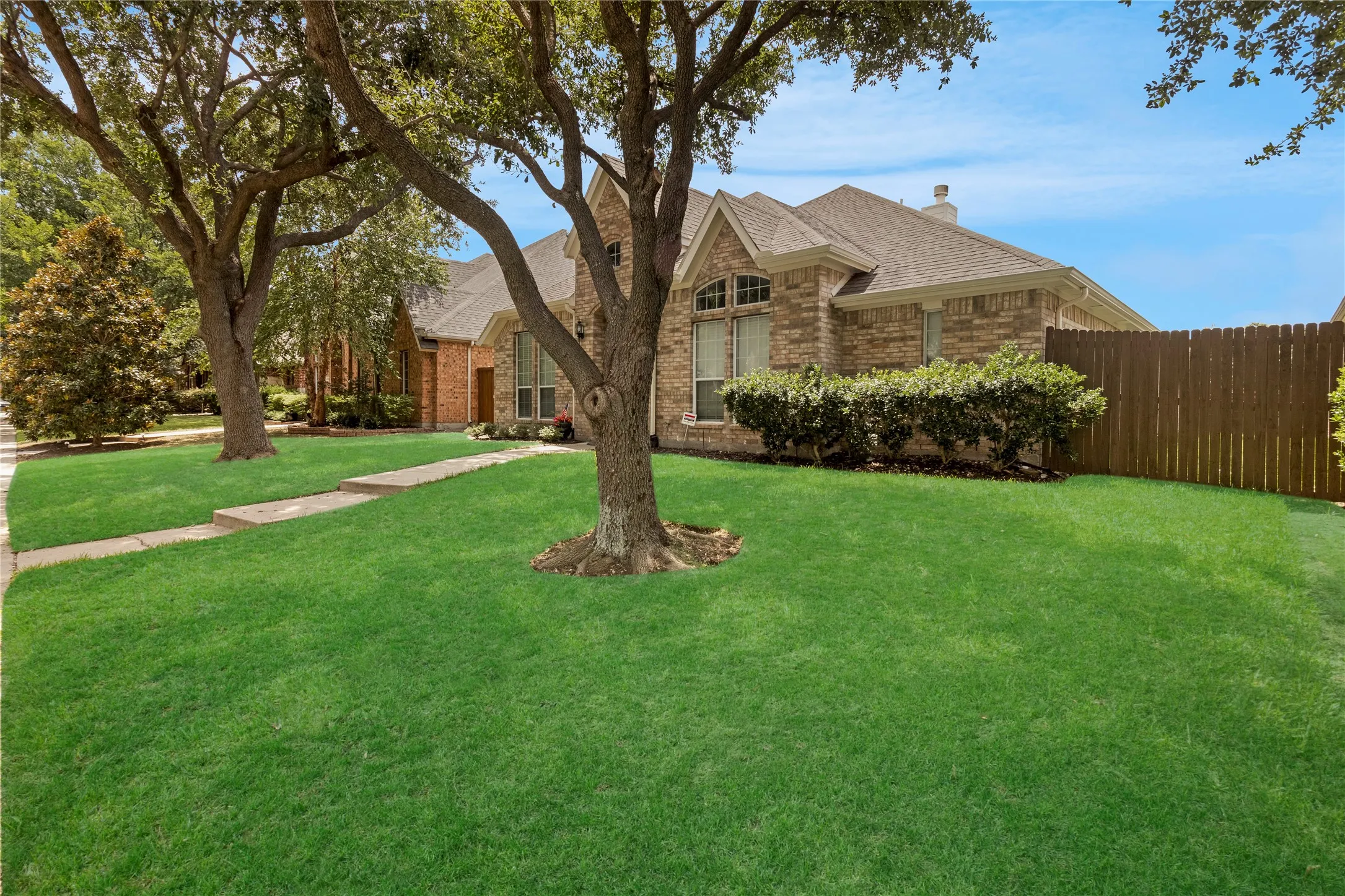 Brick exterior residence featuring a gabled roofline and an attached garage