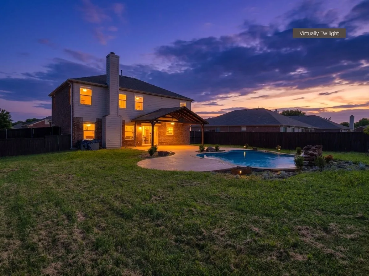 Expansive backyard featuring a gunite swimming pool with rock waterfall, a covered patio with recessed lighting, and a generously sized lawn