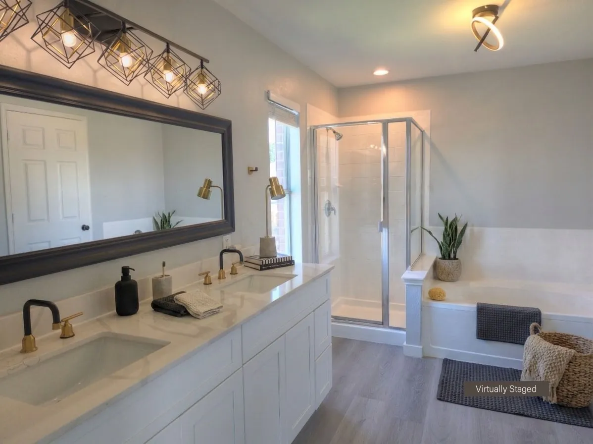 Dual vanity with white cabinetry, light-toned countertop, and black and gold-toned fixtures
