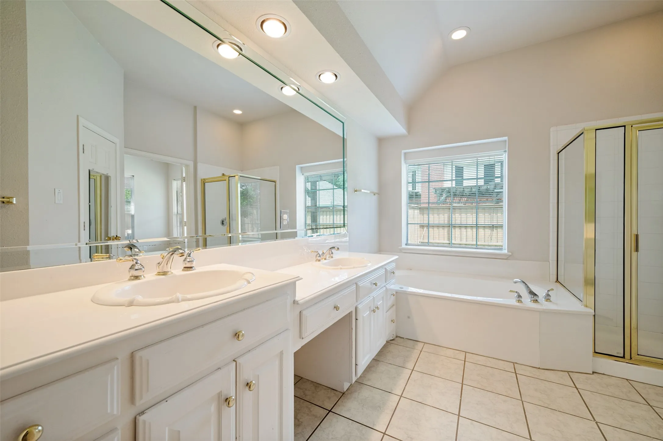 Large primary bath with walk in shower and walk in closet.