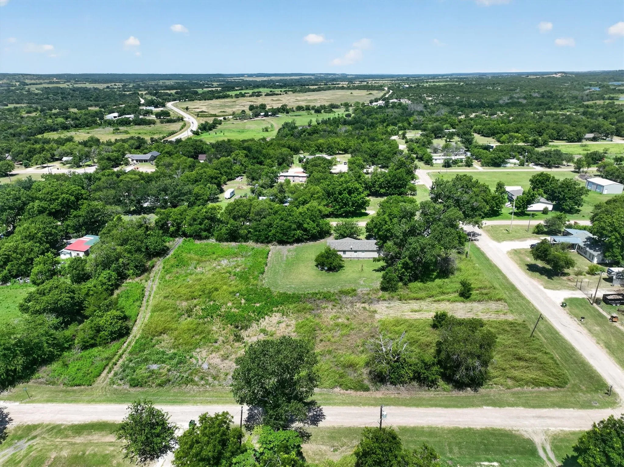 Expansive undeveloped land parcel featuring existing road frontage