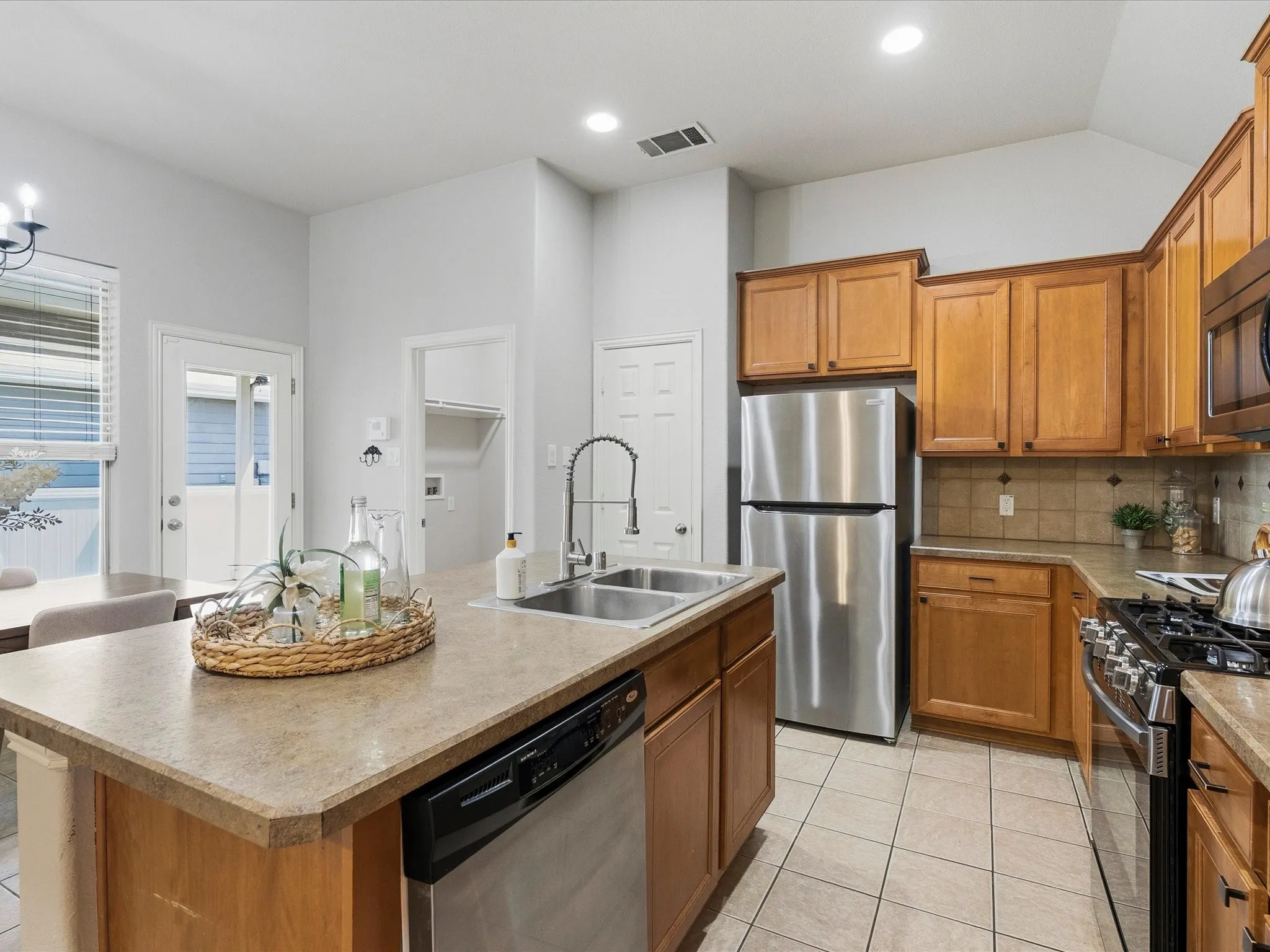 Corian counters, island with breakfast bar, stainless steel appliances