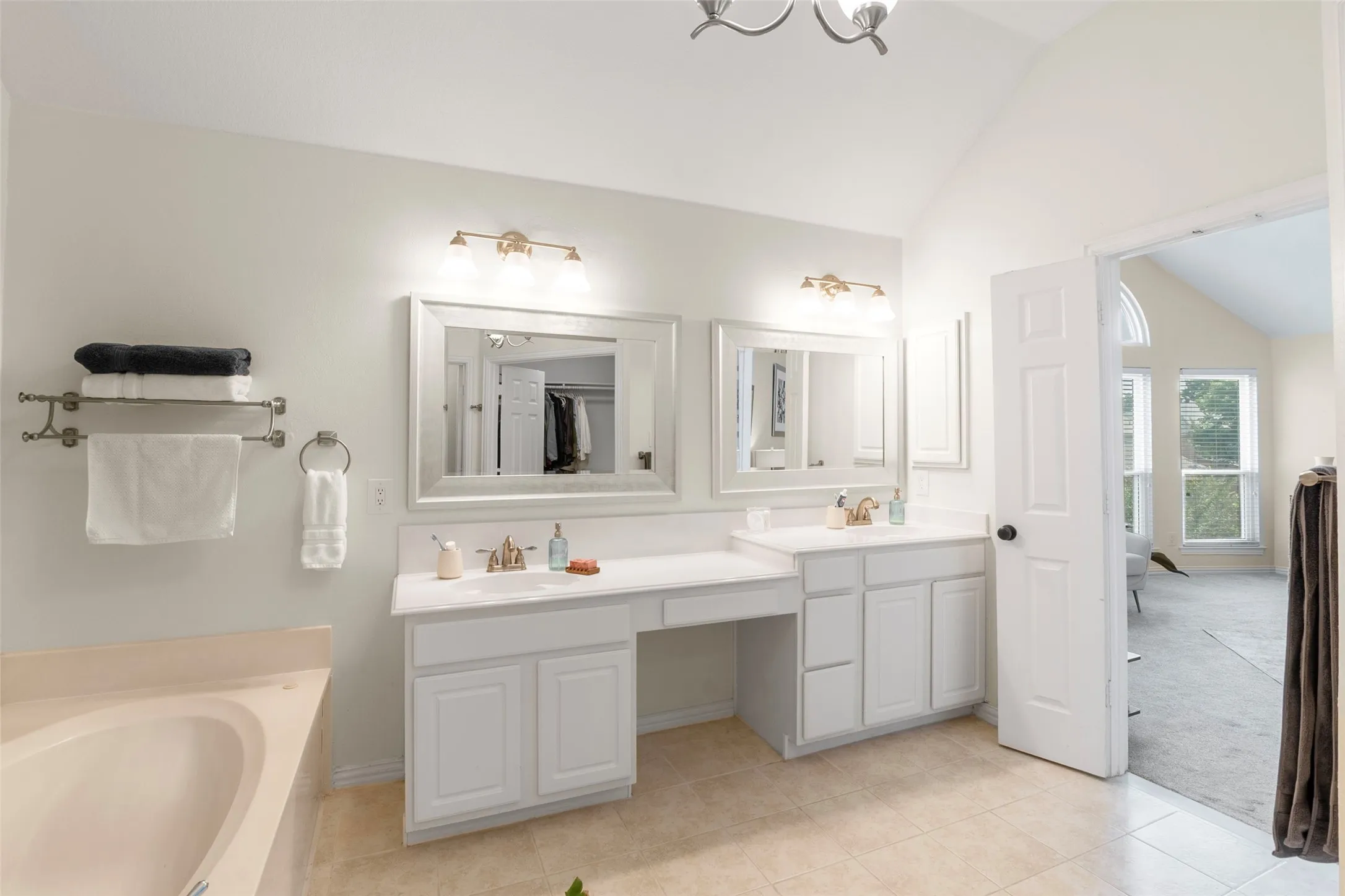 Double vanity with white cabinetry and integrated sinks