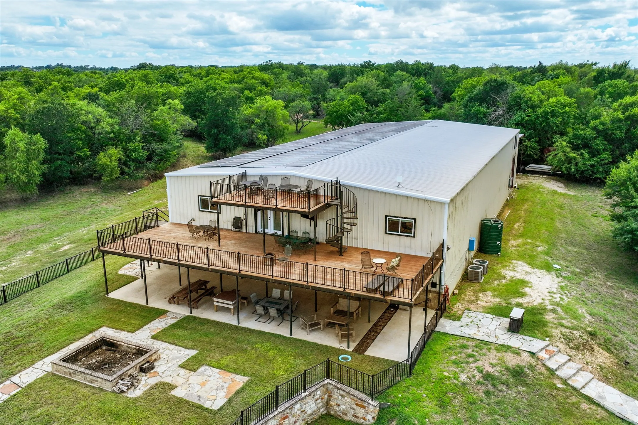 Three stories of outdoor entertaining space, along with a fenced in yard and oversized built in firepit.