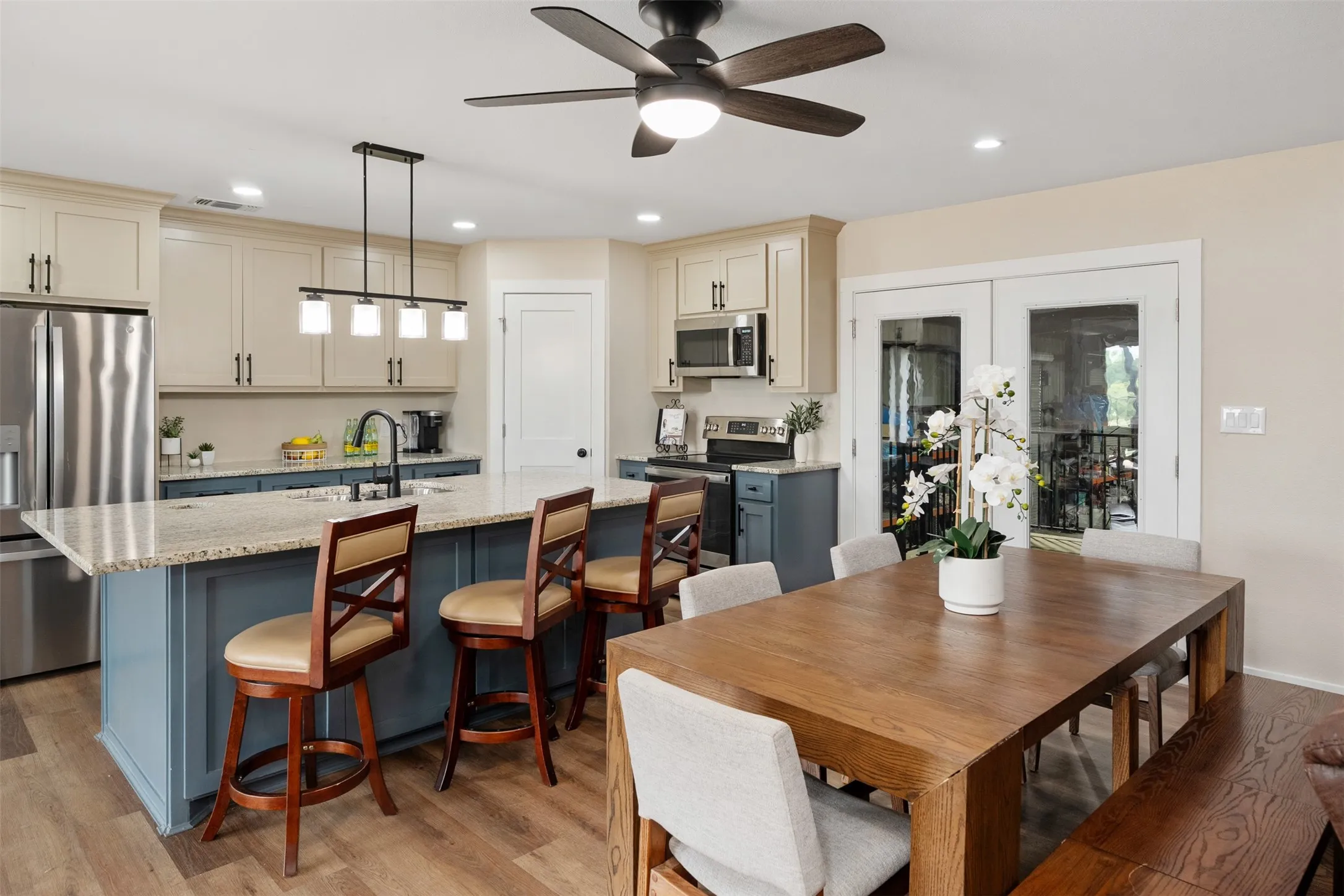 Upstairs kitchen and dining with French doors leading to the workshop.