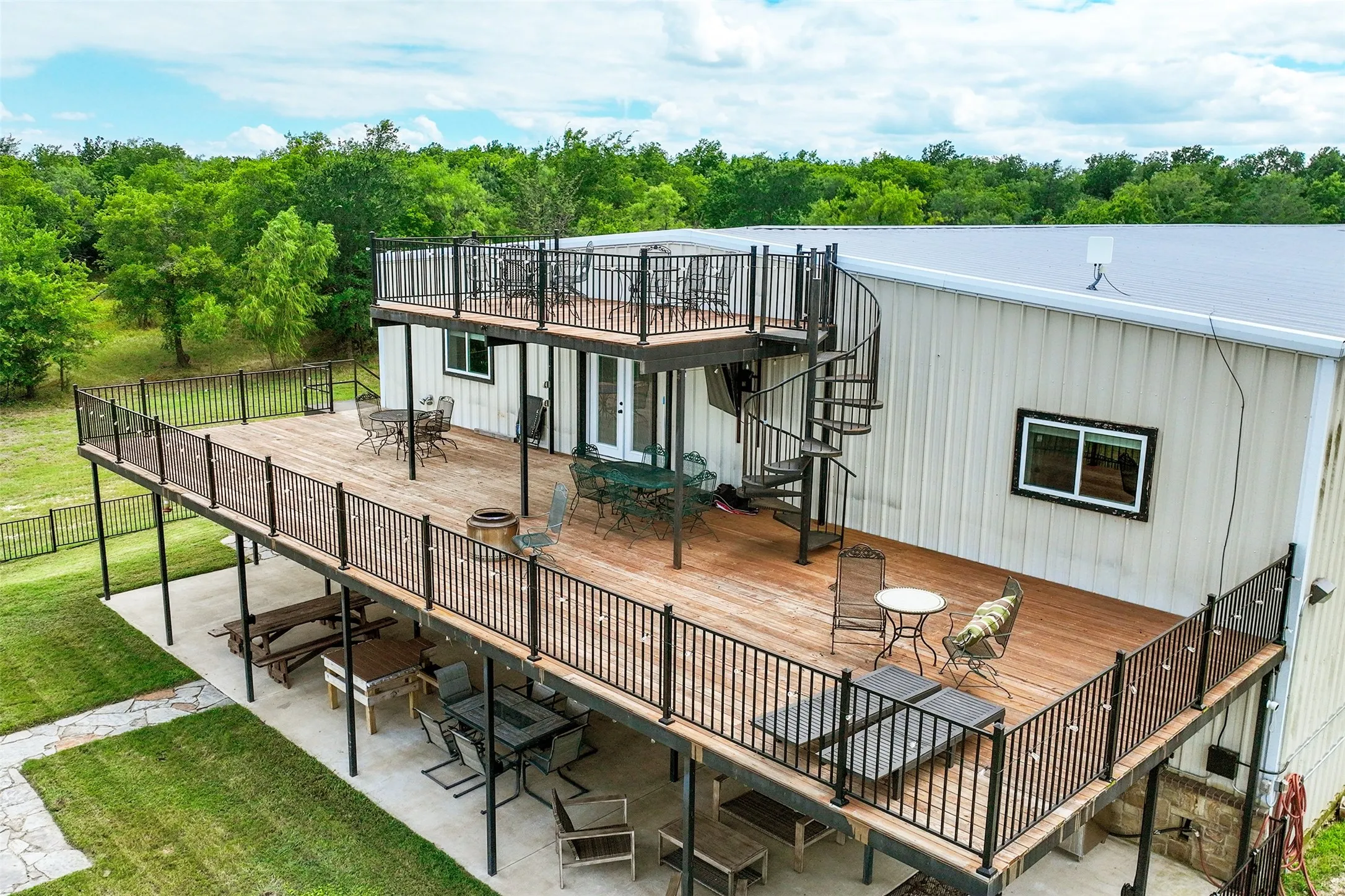 Three stories of outdoor entertaining space, along with a fenced in yard and oversized built in firepit.