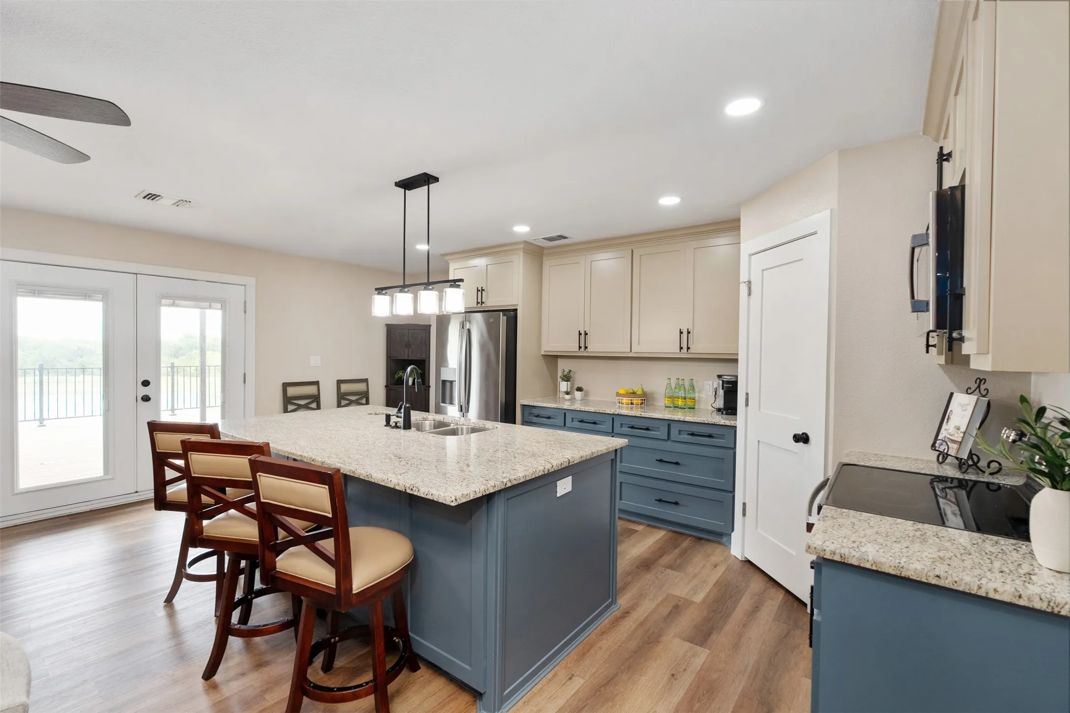 Upstairs kitchen with French doors leading to the 2nd story deck.