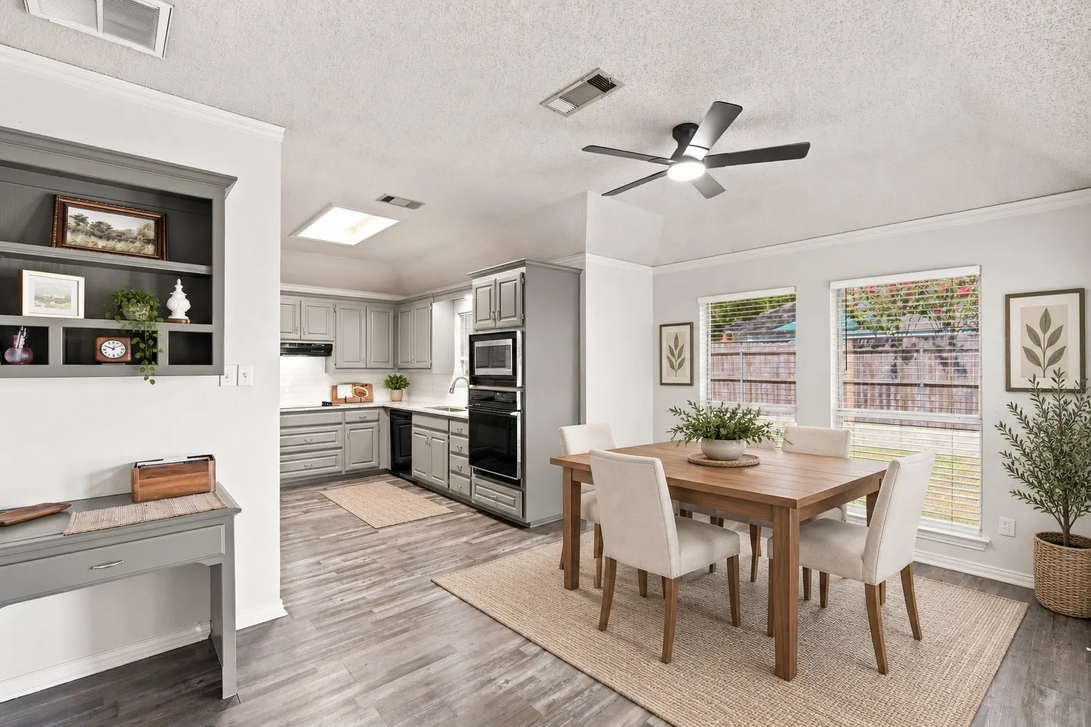 virtually staged breakfast area to show optional look with a table and chairs placed in this open concept kitchen.
