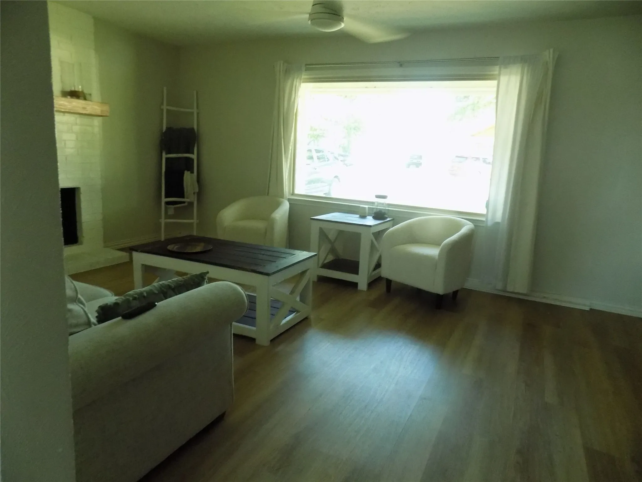 Lovely picture window and awesome flooring in living room.