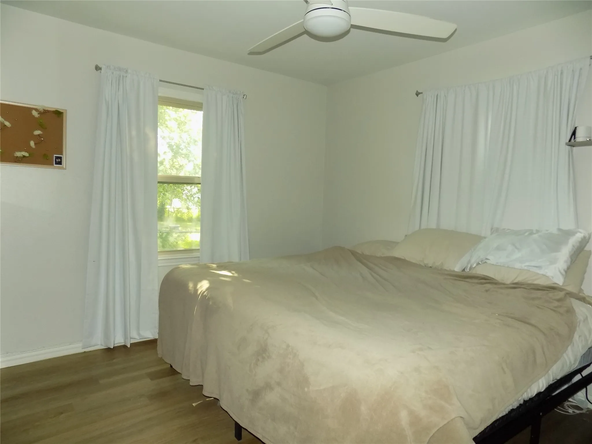 Large primary bedroom with good lighting.