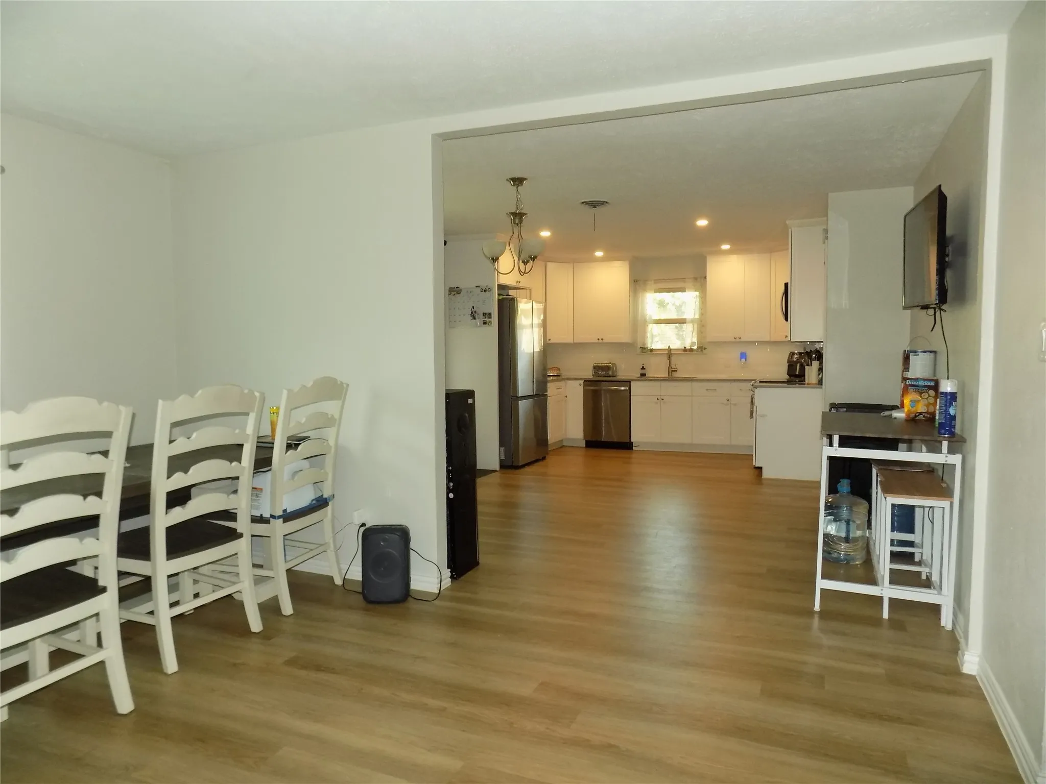 Second dining area leading into large kitchen.
