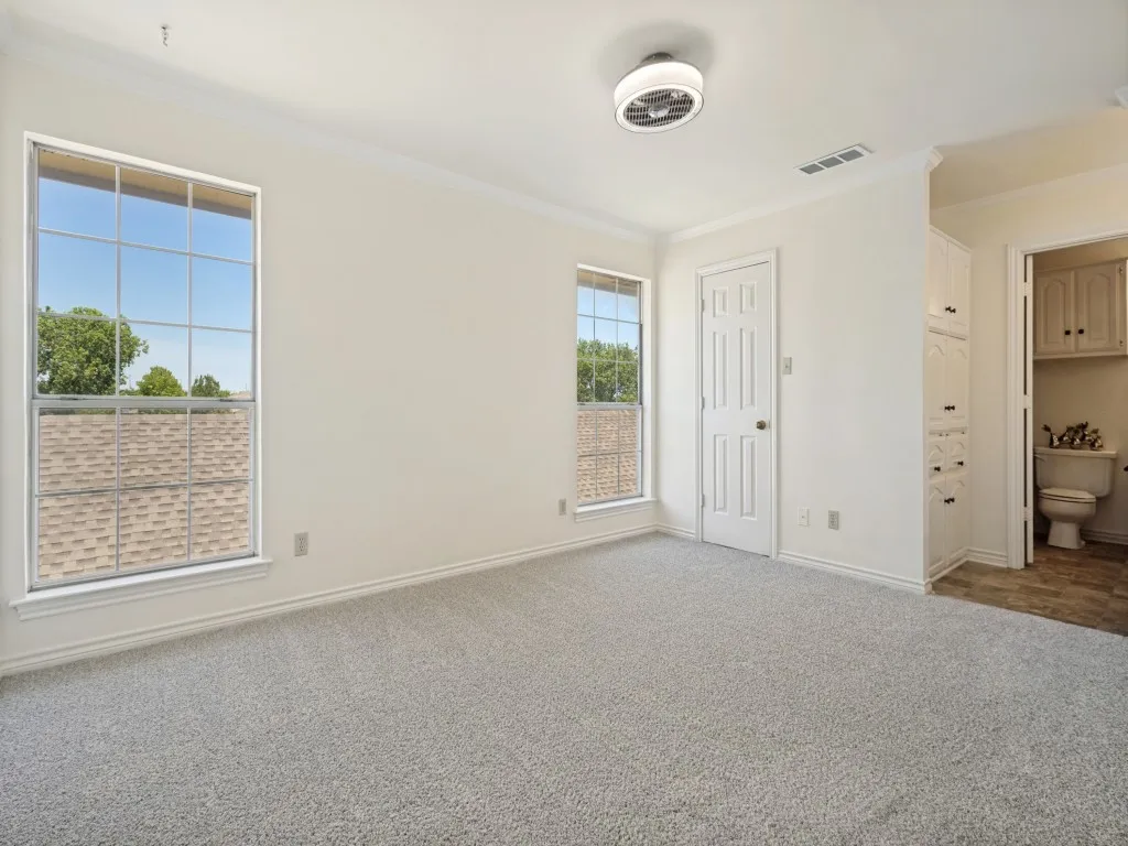 Nice size primary bedroom with large walk-in closet plus cabinets and direct bathroom access.