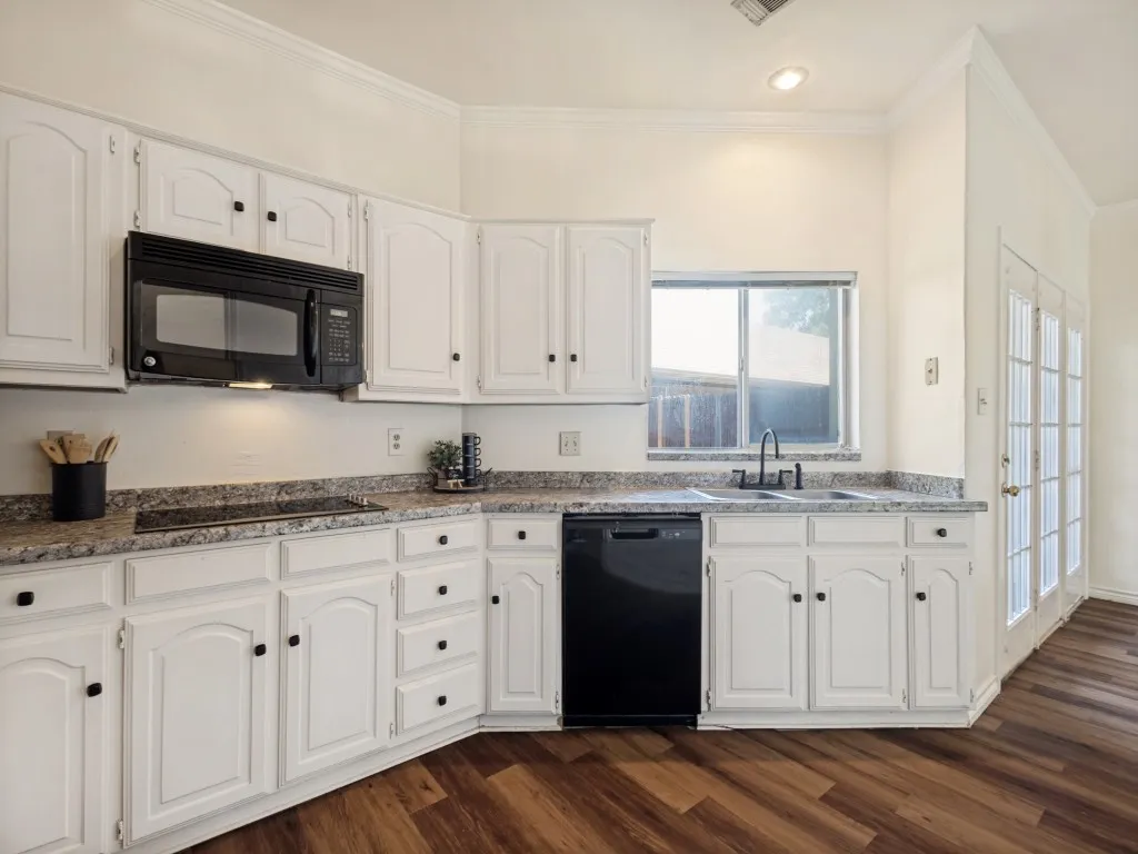 Kitchen features tons of cabinets and a bank of pantry cabinets too.