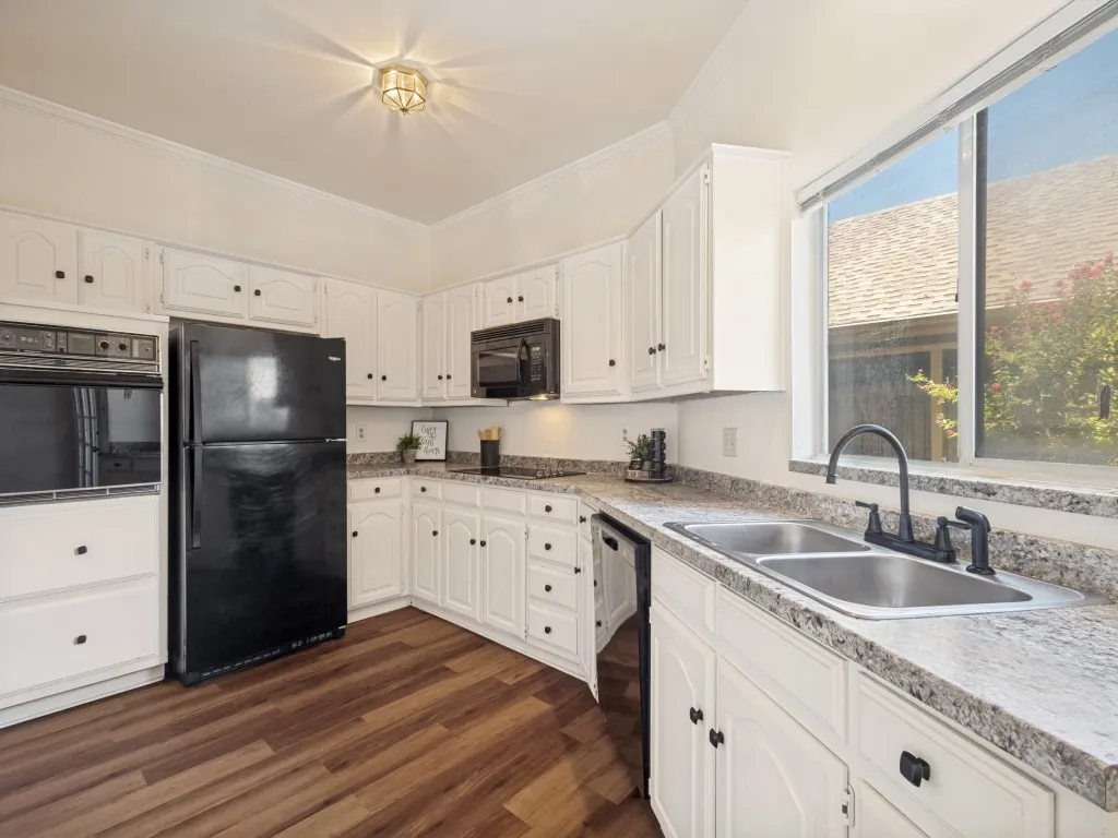 Kitchen has updated colors with black and white traditional color scheme.