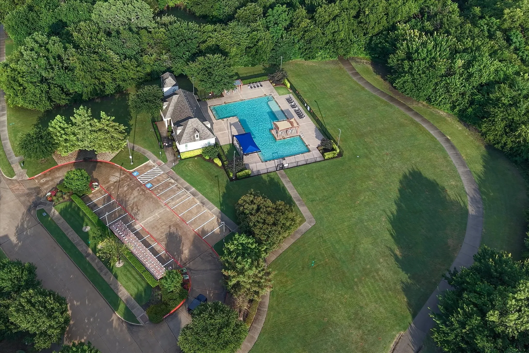 Community pool area featuring a swimming pool and a shaded lounge area and Green Park near by