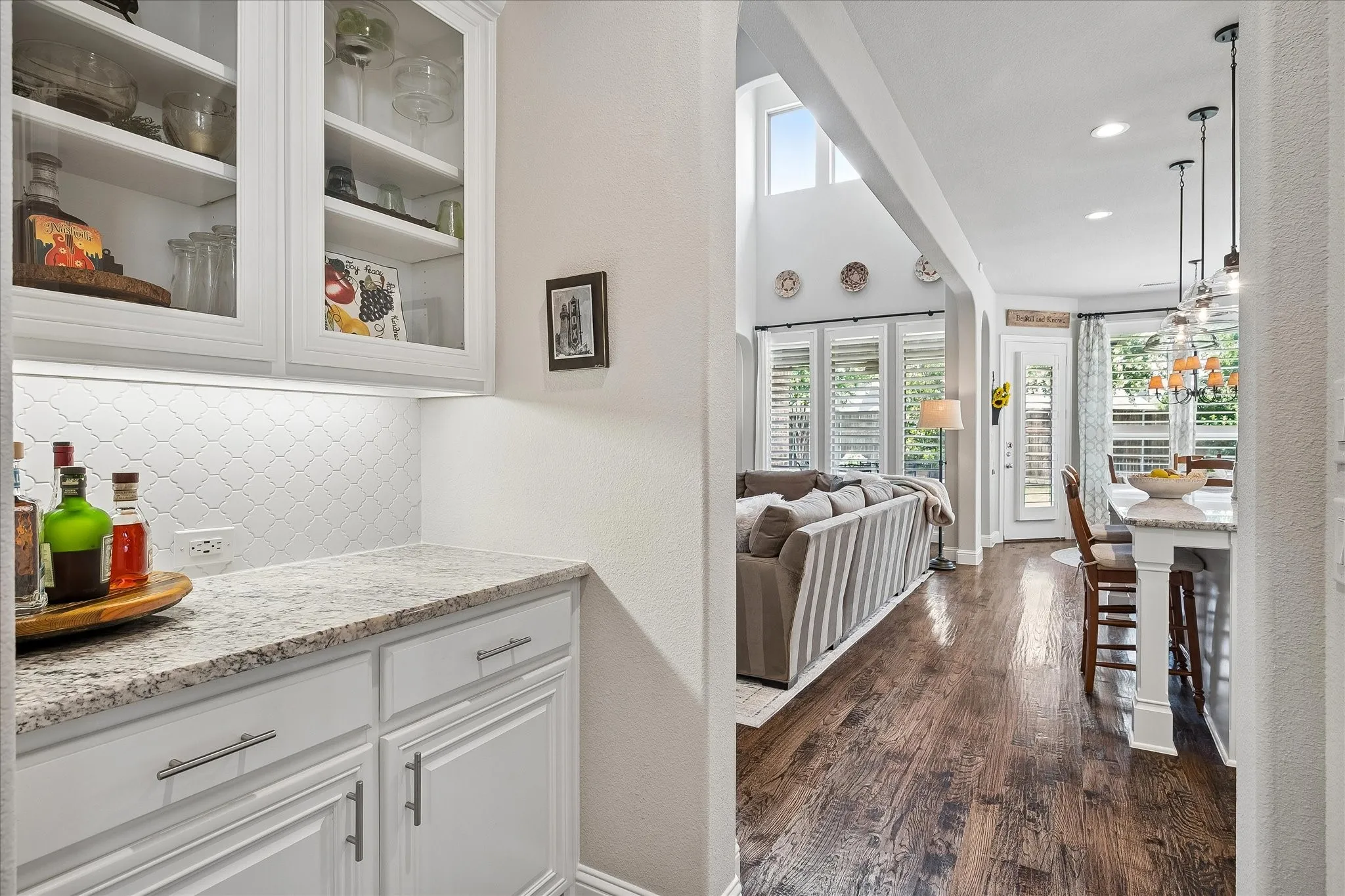 Built-in cabinetry with glass-front uppers and under-cabinet lighting