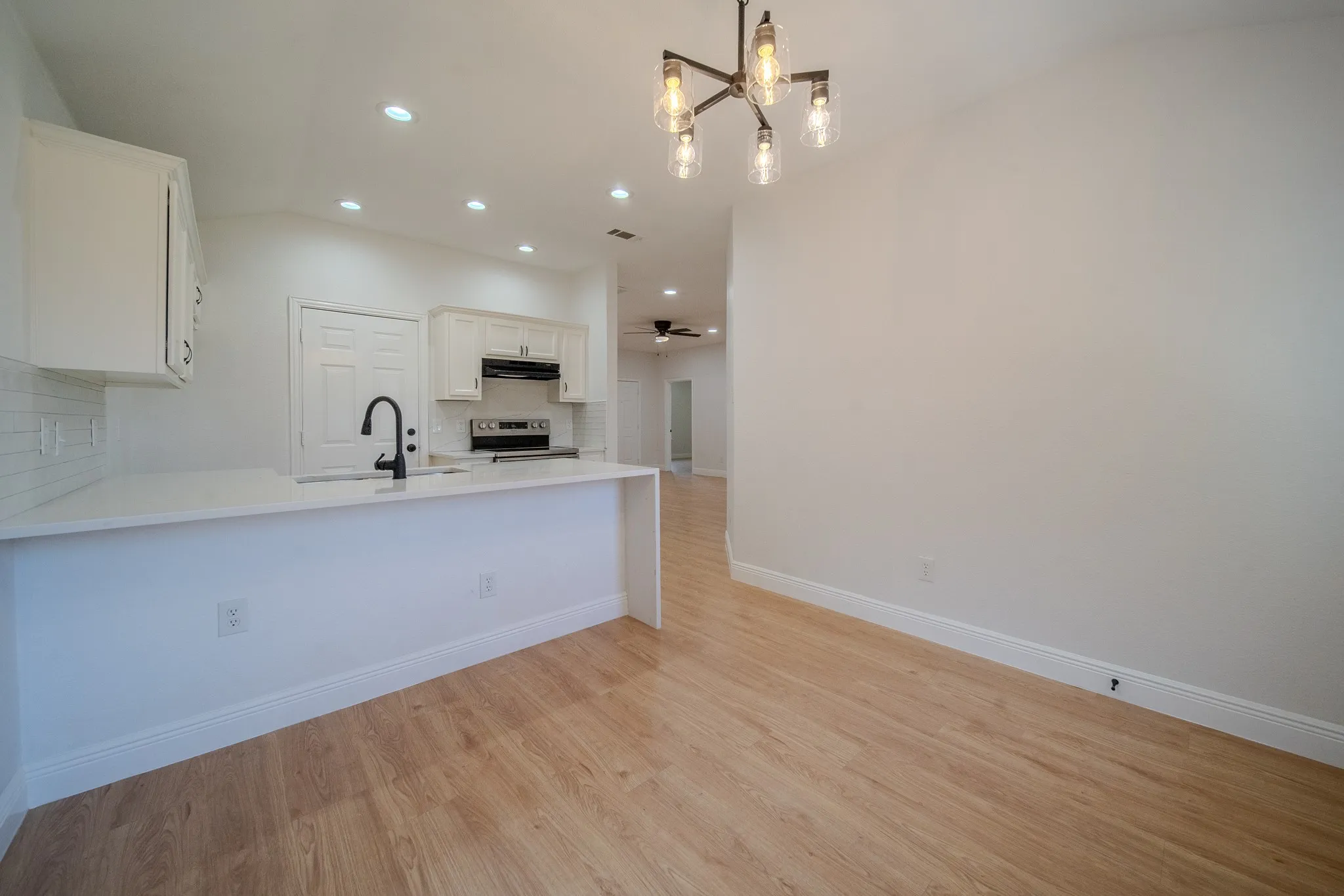 Open-concept kitchen and dining area with wood-finish flooring